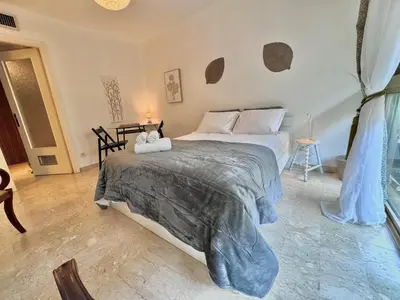 a bedroom with a bed with a teddy bear on it at A G Cocon Massenet - Grimaldi - Promenade des Angl in Nice