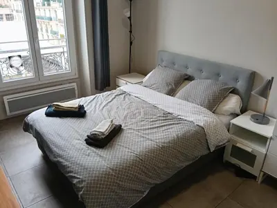 a bedroom with a bed with two bags on it at Studio central Nice in Nice