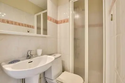 a bathroom with a toilet and a sink and a shower at T3 avec terrasse vue sur mer à 400m de la plage in Nice