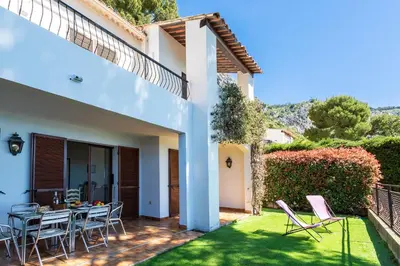 a patio with a table and chairs in a yard at LA SOLEILLADE VI4451 By Riviera Holiday Homes in Èze