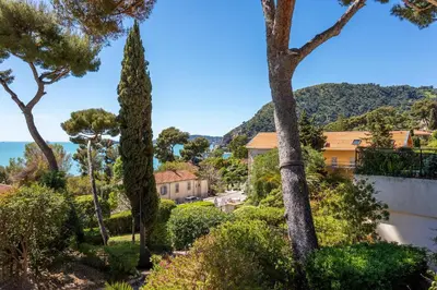 a view from the garden of a house with trees at LA SOLEILLADE VI4451 By Riviera Holiday Homes in Èze