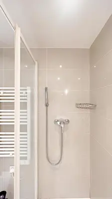 a shower with a glass door in a bathroom at La Bella Niçoise in Nice