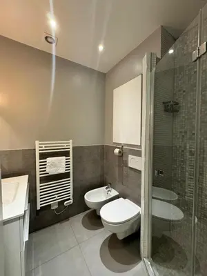 a bathroom with a toilet and a sink and a shower at Suite Doulce France FSHH in Nice