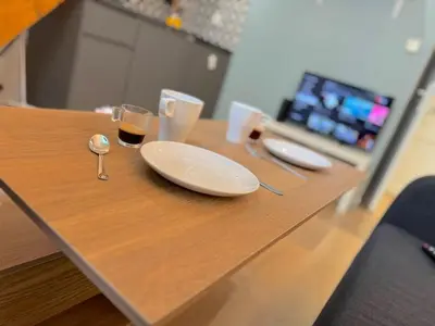 a wooden table with two plates and glasses on it at ⁂ Appartement élégant et central à Nice in Nice