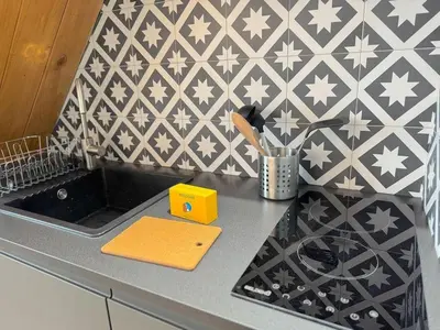 a kitchen counter with a sink and a wall at ⁂ Appartement élégant et central à Nice in Nice