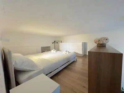 a bedroom with a bed and a vase of flowers at ⁂ Appartement élégant et central à Nice in Nice