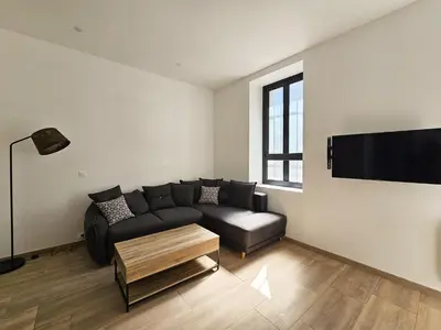 a living room with a couch and a flat screen tv at Joli studio rénové en centre-ville proche tramway in Nice