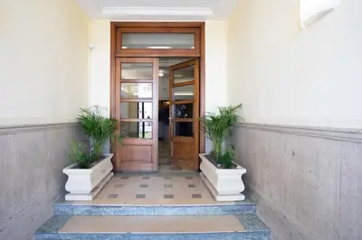 a door in a building with two potted plants at #37 1BDR Bagatelle, Promenade, sea front Balcony & AC in Nice