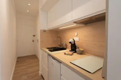 a kitchen with white cabinets and a counter top at #26 Idealy located flat AC 2mins walk to Sea balcony in Nice