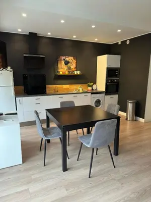 a kitchen with a dining room table and chairs at Spacious Riviera Studio in Nice