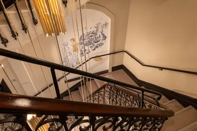 a spiral staircase with a painting on the wall at Ikonik Marengo in Nice