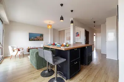 a kitchen with a island in the middle of a room at MY CASA - DELFINO - Charming roof terrace apartment w AC in Nice