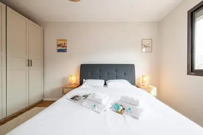 a bedroom with a large white bed with two lamps at MY CASA - DELFINO - Charming roof terrace apartment w AC in Nice