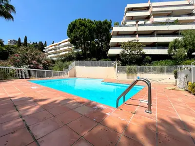 an empty swimming pool in front of a building at La Pastourelle Studio Close to Sea Pool Parking in Nice