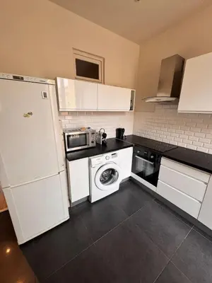 a kitchen with white cabinets and a washer at Hype-Center Balcony 3BR AC Near Tram for6 guests in Nice