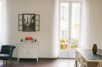 a dining room with a table and a chair at Hype-Center Balcony 3BR AC Near Tram for6 guests in Nice