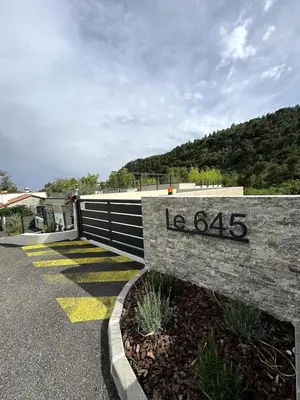 a stone retaining wall with a sign on it at Appartement entre Monaco et Nice Calme et tout équipé in Èze