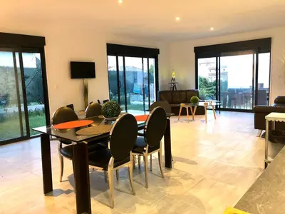 a living room with a dining table and chairs at Villa La Mer new apartment 75 m2 very quiet in Cagnes-sur-Mer