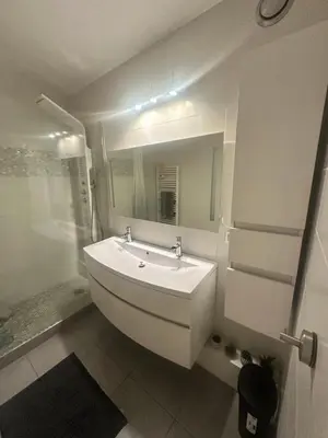 a white bathroom with a sink and a mirror at Apartment near Beach-Airport Open 24h in Saint-Laurent-du-Var