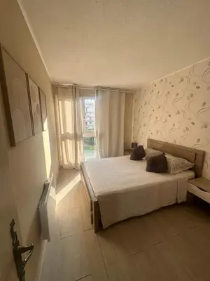 a bedroom with a bed and a large window at Apartment near Beach-Airport Open 24h in Saint-Laurent-du-Var