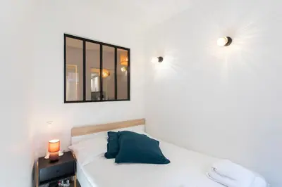 a bedroom with a bed with a mirror on the wall at #16 1BDR Flower market, Old Town, 1min beach AC in Nice