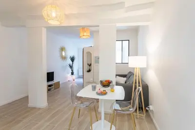 a living room with a table and a couch at #16 1BDR Flower market, Old Town, 1min beach AC in Nice