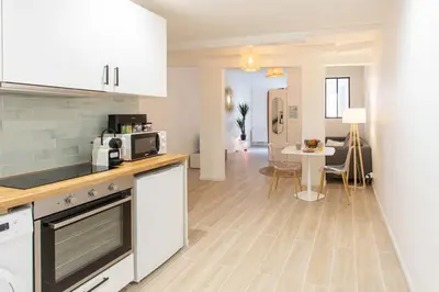 a kitchen with white cabinets and a table in a room at #16 1BDR Flower market, Old Town, 1min beach AC in Nice