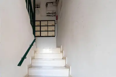 a stairway with white stairs in a white wall at #16 1BDR Flower market, Old Town, 1min beach AC in Nice