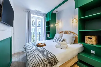 a green and white bedroom with a bed and shelves at NEW! Remodeled & Spacious 4 Bedroom - 3 Bath - Heart of Nice - AC in all rooms - With a large elevator in Nice