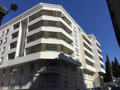 a tall white building with a lot of windows at Ma place au sud Nice 604 in Nice