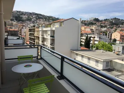 a balcony with a table and chairs and a city at Ma place au sud Nice 604 in Nice