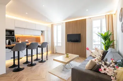 a living room with a couch and a table at Design Apartment near the Beaches of Nice in Nice