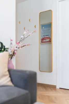 a mirror in a living room with a couch at Design Apartment near the Beaches of Nice in Nice