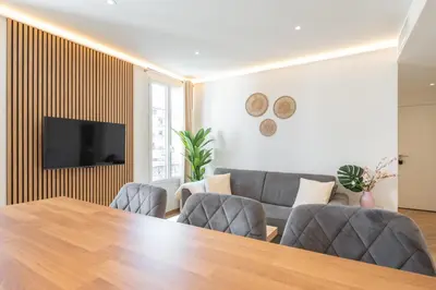 a living room with a table and a couch at Design Apartment near the Beaches of Nice in Nice