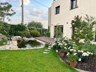 a garden with a pond and a house at Luxury villa piscine chauffée confort exceptionnel in Nice