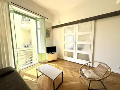 a living room with a couch and a table at B G La Residence Grimaldi Promenade des Anglais in Nice