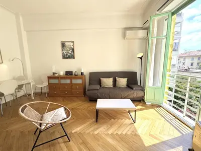 a living room with a couch and a table at B G La Residence Grimaldi Promenade des Anglais in Nice