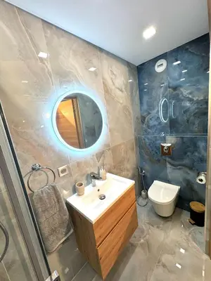 a bathroom with a sink and a toilet and a mirror at Appartement Nice Magnan promenade in Nice