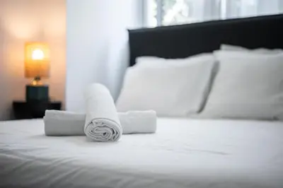 a rolled up towel sitting on top of a bed at Nice - Mordern Apartment Sea Close in Nice