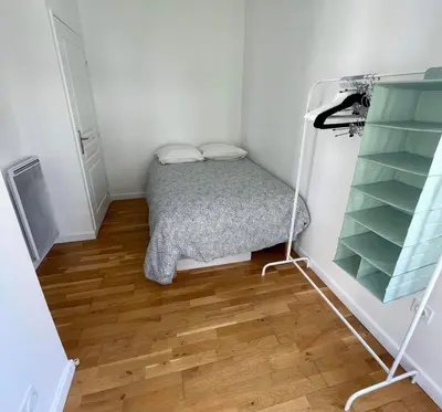 a small bedroom with a bed and shelves at Nice two-rooms with balcony in Nice in Nice