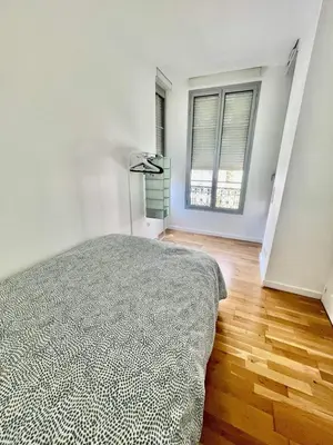 a white bedroom with a bed and two windows at Nice two-rooms with balcony in Nice in Nice