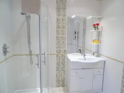 a white bathroom with a sink and a shower at Unique havre de paix in Nice