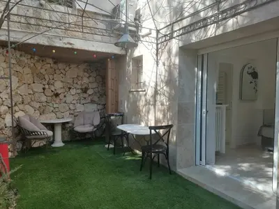 a patio with a table and chairs with green grass at Unique havre de paix in Nice