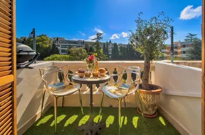 a small patio with a table and chairs on a balcony at Nice - Little Studio with Sunny Terrace in Nice