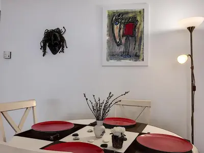 a dining room table with two red plates on it at Nestor&Jeeves - VILLA HARMONIE TERRASSE - Central - Free parking in Nice