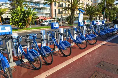 a row of blue bikes parked in a parking lot at Nestor&Jeeves - VILLA HARMONIE TERRASSE - Central - Free parking in Nice