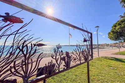 a view of the beach from a fence with a view at Contemporary 2P Studio Just Steps from the Beach in Cagnes-sur-Mer