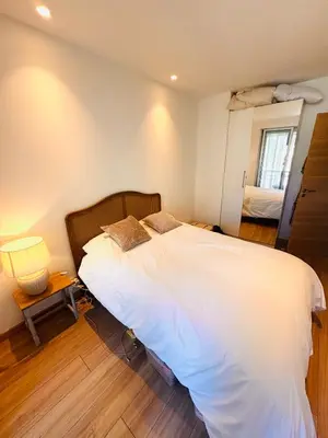a bedroom with a large white bed and a window at Les Floralies - Beaulieu-sur-Mer in Beaulieu-sur-Mer