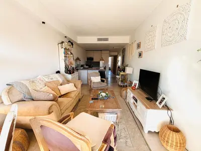 a living room with a couch and a table at Les Floralies - Beaulieu-sur-Mer in Beaulieu-sur-Mer