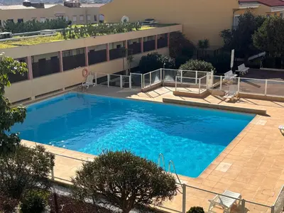 a large swimming pool in front of a building at Les Floralies - Beaulieu-sur-Mer in Beaulieu-sur-Mer